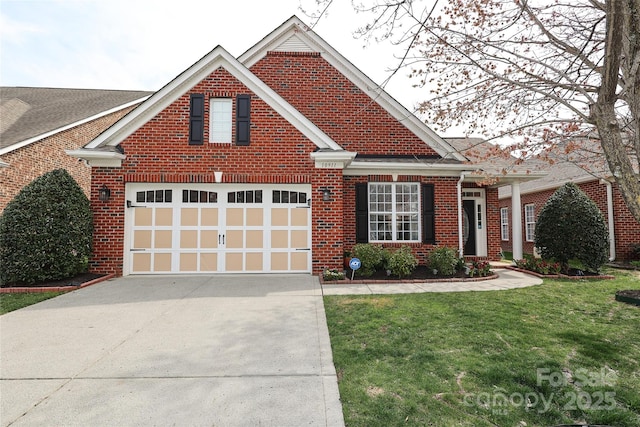 traditional-style house with a front yard, brick siding, a garage, and driveway