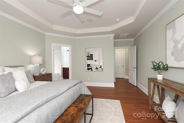 bedroom with baseboards, dark wood finished floors, ornamental molding, a raised ceiling, and a ceiling fan