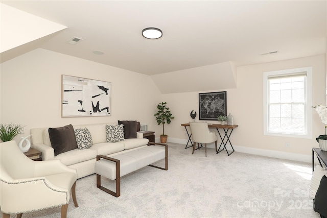 living room with light carpet, visible vents, and vaulted ceiling