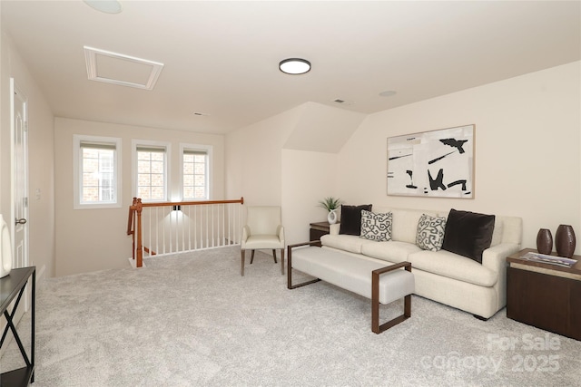 living room with visible vents, carpet, and attic access