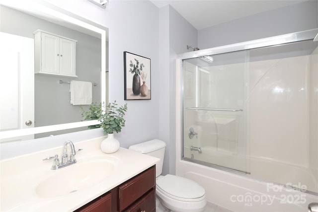 full bath featuring vanity, toilet, and bath / shower combo with glass door