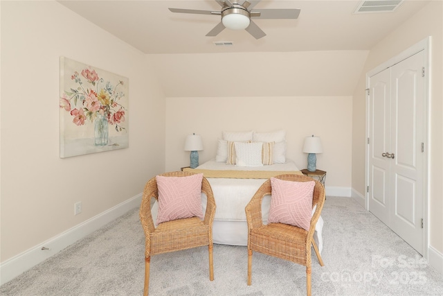 carpeted bedroom featuring lofted ceiling, baseboards, and visible vents