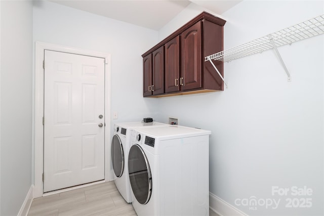 washroom featuring cabinet space and washer and dryer