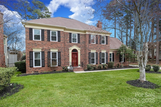 view of front of property featuring brick siding, crawl space, a chimney, and a front lawn