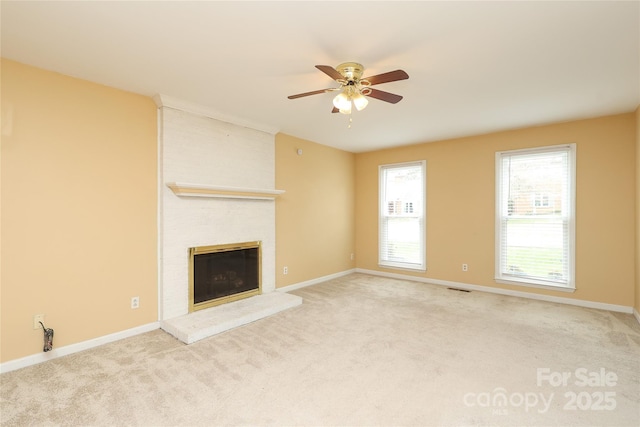 unfurnished living room featuring visible vents, a brick fireplace, ceiling fan, and carpet flooring