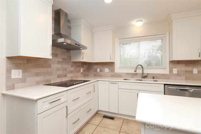 kitchen with visible vents, black electric stovetop, light tile patterned flooring, wall chimney exhaust hood, and a sink