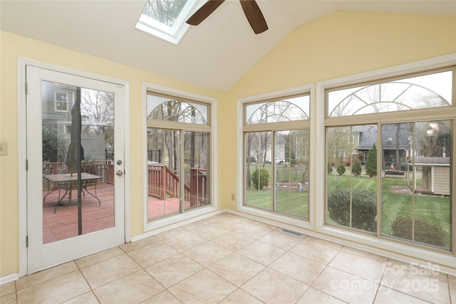 unfurnished sunroom featuring vaulted ceiling with skylight, visible vents, and ceiling fan