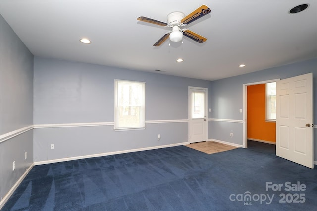 carpeted empty room with visible vents, recessed lighting, a ceiling fan, and baseboards