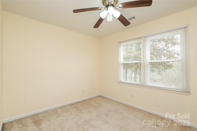 unfurnished room featuring visible vents, light carpet, and baseboards