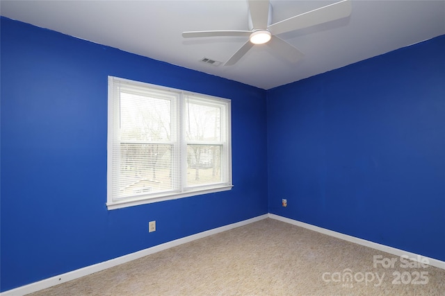 empty room with baseboards, carpet floors, and ceiling fan