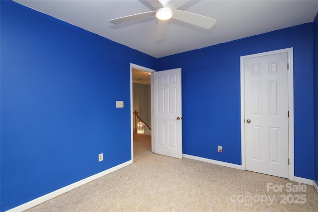 unfurnished bedroom with baseboards, carpet floors, and ceiling fan