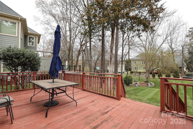 wooden deck featuring a yard