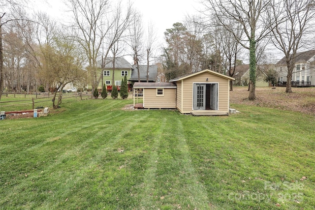 view of yard with an outbuilding and fence