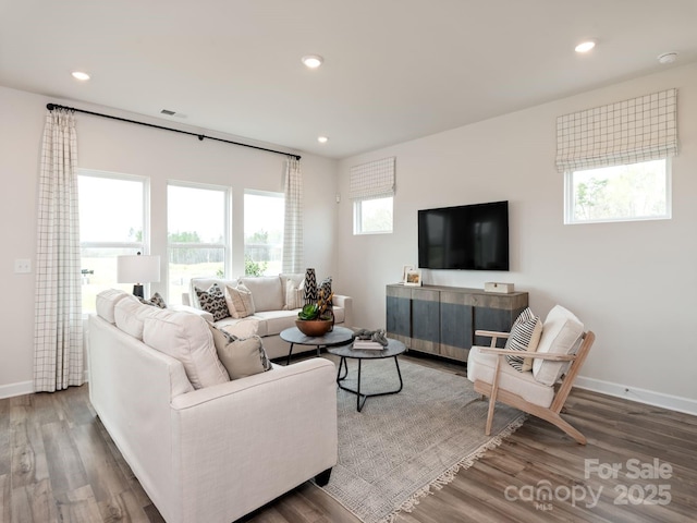 living area with recessed lighting, baseboards, and wood finished floors