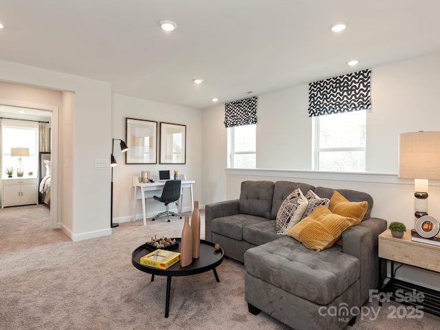 living area with recessed lighting, light colored carpet, and baseboards