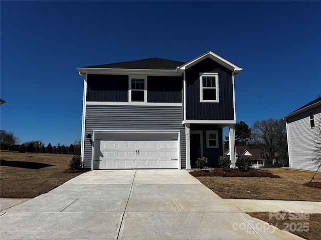 view of front of property with an attached garage, board and batten siding, and driveway