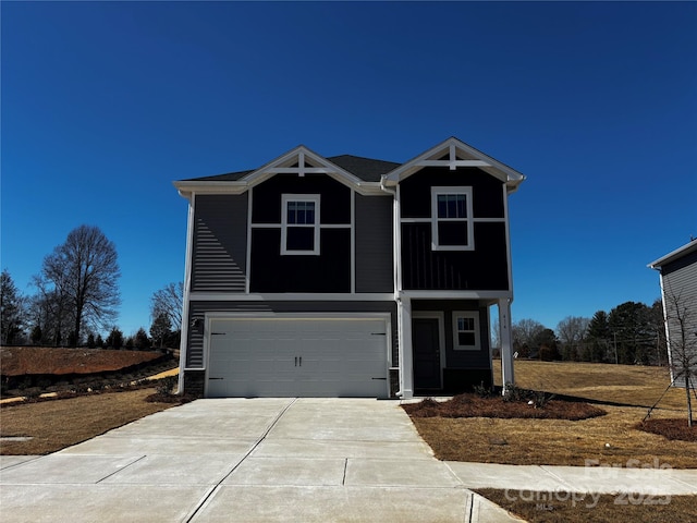 view of front of house with concrete driveway and a garage