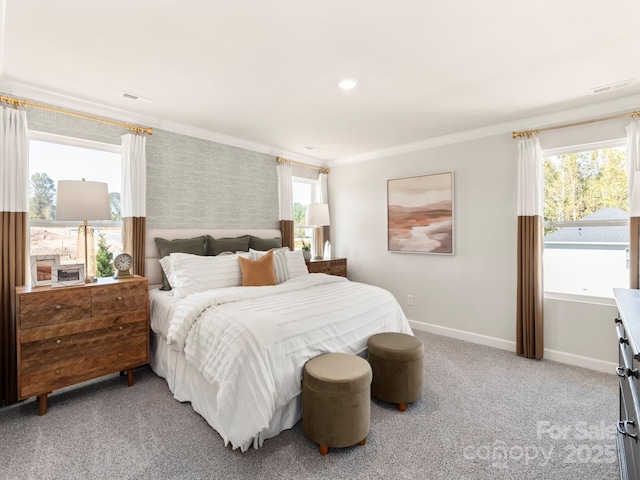 carpeted bedroom featuring crown molding, visible vents, and baseboards