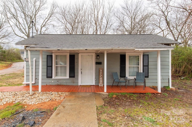 bungalow-style house featuring covered porch and a shingled roof