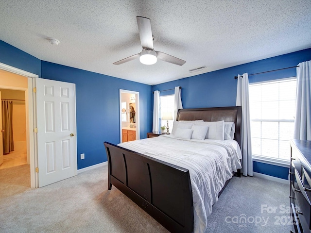 carpeted bedroom with visible vents, multiple windows, and baseboards