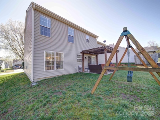 rear view of property featuring a yard, a patio, and a pergola