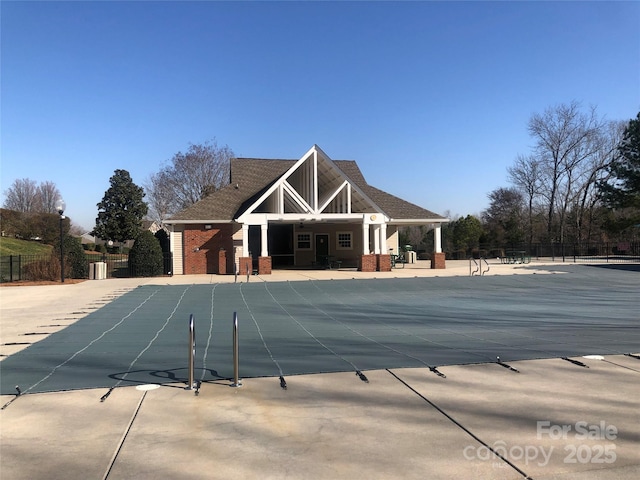 pool with fence and a patio area