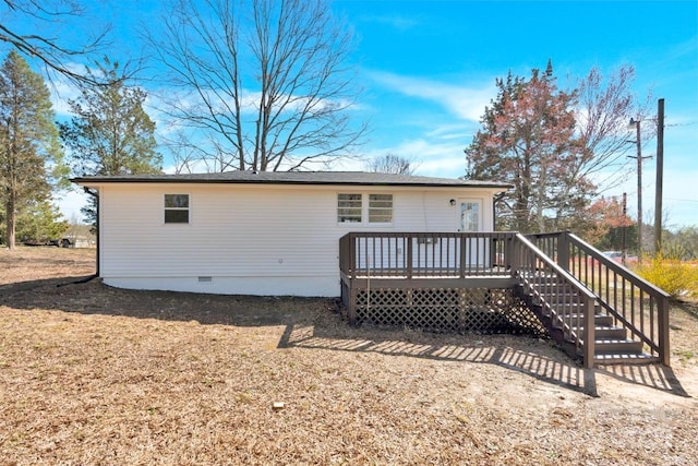 rear view of property with a deck, stairs, and crawl space