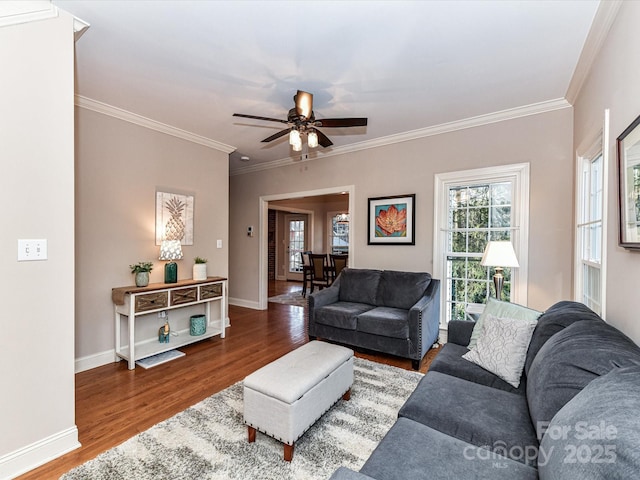 living area featuring a wealth of natural light, baseboards, and wood finished floors