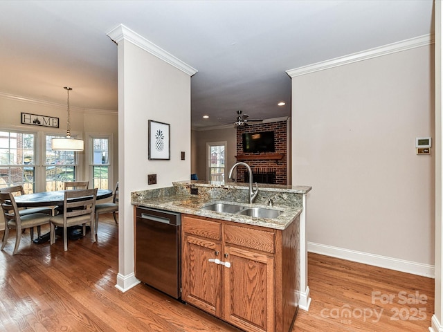 kitchen featuring light wood finished floors, dishwasher, ornamental molding, brown cabinetry, and a sink