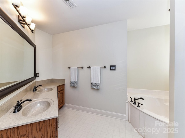 bathroom featuring a sink, visible vents, baseboards, and a garden tub