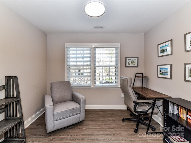 office featuring wood finished floors, visible vents, and baseboards