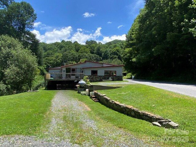 895 Laurel Valley Rd, Mars Hill, NC 28754 - view of front of property with driveway, a view of trees, a front lawn, and a deck