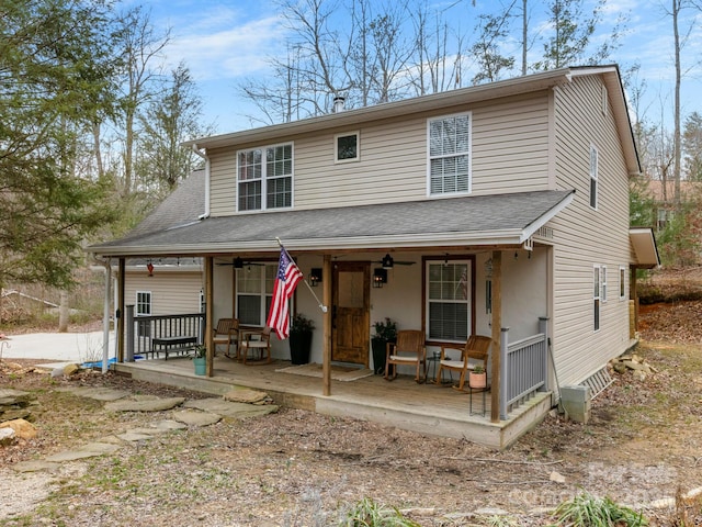 view of front of home with a porch, a ceiling fan, and roof with shingles