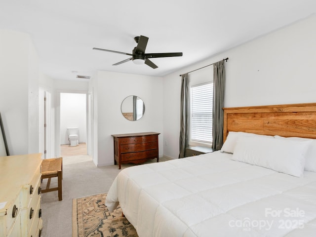 bedroom featuring visible vents, light carpet, ceiling fan, and ensuite bathroom