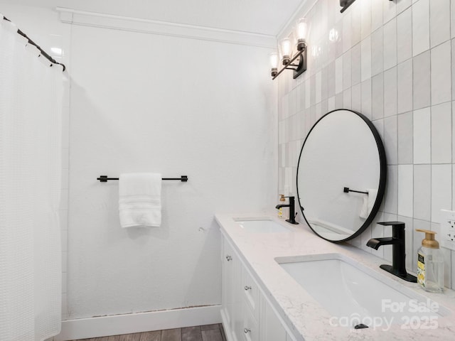 full bath with double vanity, ornamental molding, tile walls, and a sink