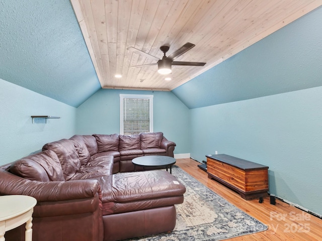 living area with vaulted ceiling, wooden ceiling, light wood finished floors, and ceiling fan