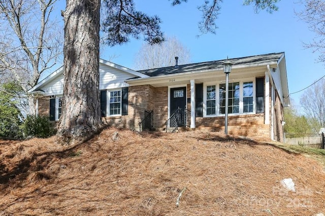 single story home with fence and brick siding