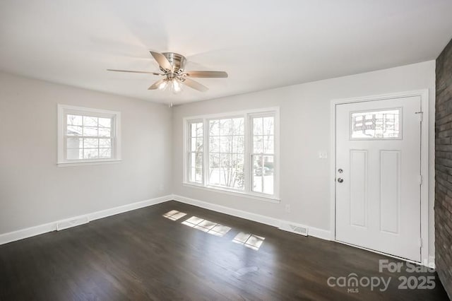 entryway featuring visible vents, baseboards, ceiling fan, and dark wood-style flooring