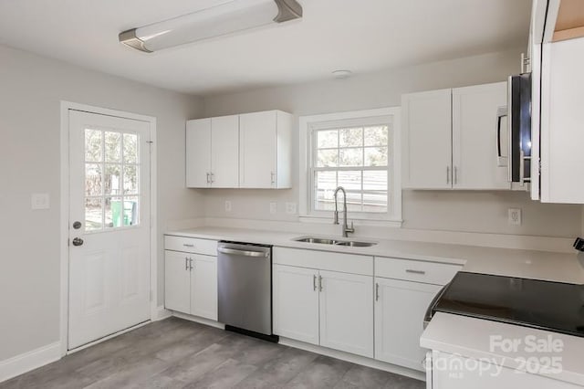 kitchen with white cabinetry, plenty of natural light, appliances with stainless steel finishes, and a sink