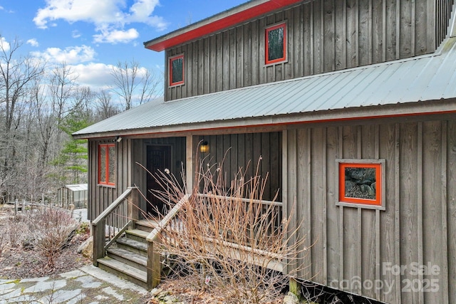 exterior space with metal roof and board and batten siding