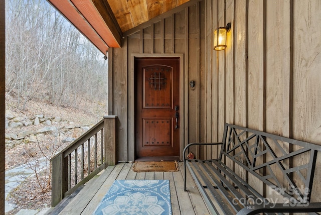 view of exterior entry featuring board and batten siding