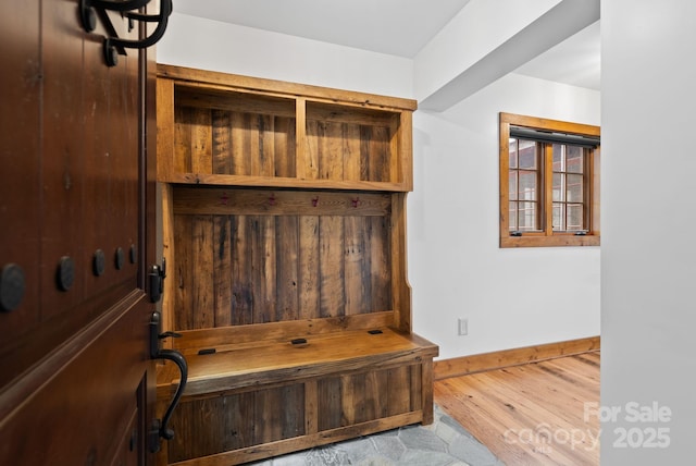 mudroom featuring baseboards and wood finished floors