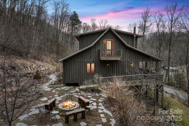 exterior space featuring an outdoor fire pit