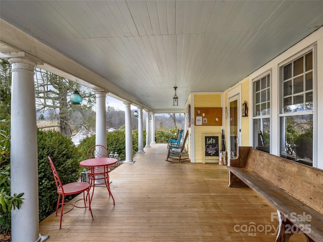 wooden terrace with a porch