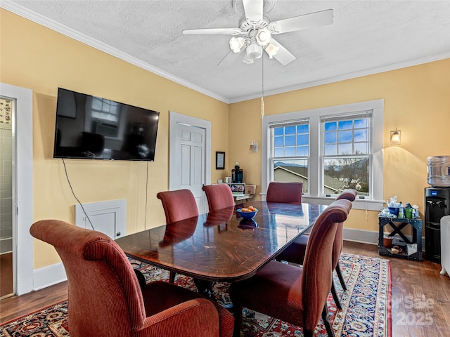 dining area with ceiling fan, crown molding, wood finished floors, and a textured ceiling