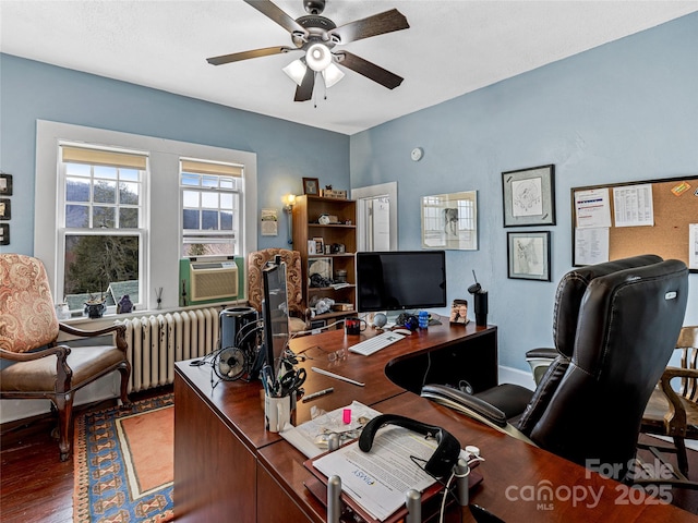 office space featuring cooling unit, radiator heating unit, ceiling fan, and wood finished floors