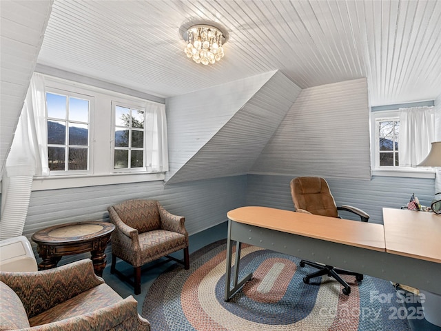 office area with a notable chandelier and lofted ceiling