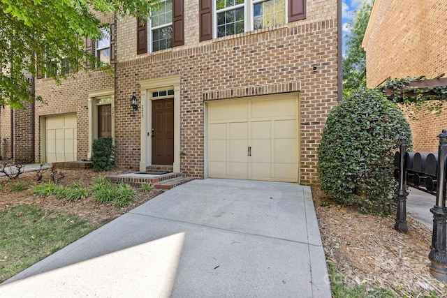 view of front of house featuring brick siding, concrete driveway, and an attached garage