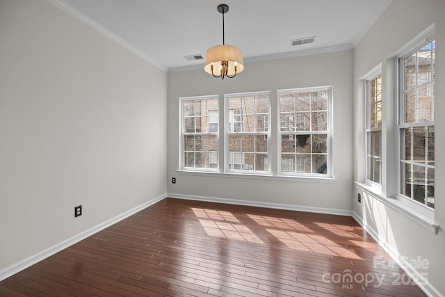 unfurnished dining area featuring dark wood-type flooring, baseboards, visible vents, and ornamental molding