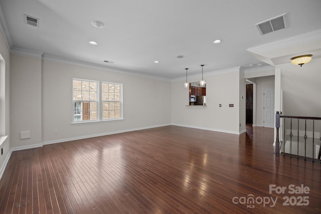 unfurnished living room featuring visible vents, wood-type flooring, and ornamental molding